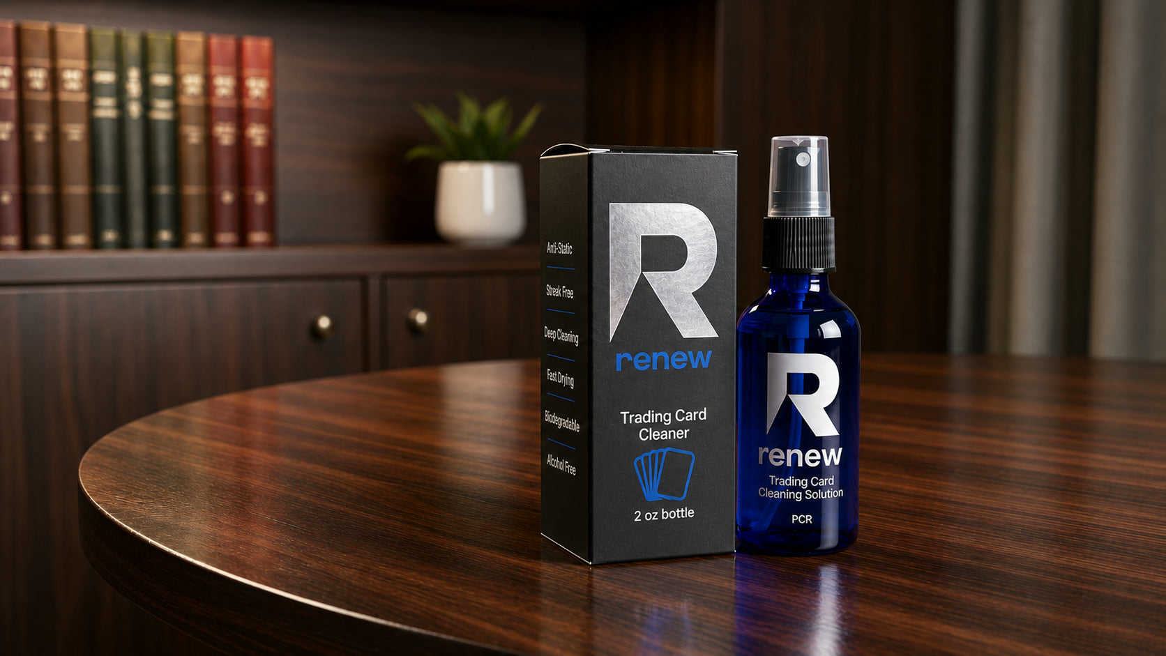The Renew 2 oz blue glass spray bottle beside its black box on a dark walnut desk